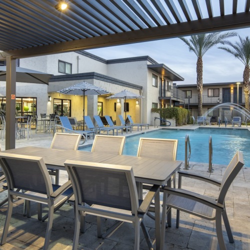 table and chairs near pool